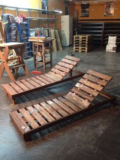 two benches made out of wooden pallets in a room filled with shelves and tables