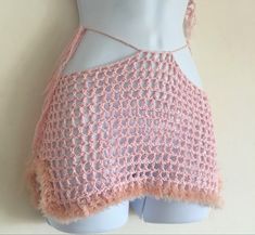 a mannequin wearing a pink crochet skirt