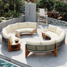 an outdoor living area with couches and tables next to a pool in the background