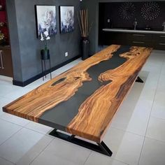 a large wooden table sitting on top of a white tile floor