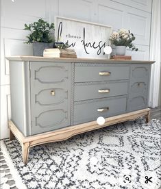 a gray dresser with gold handles and drawers