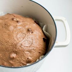 a chocolate cake in a white pot on a table