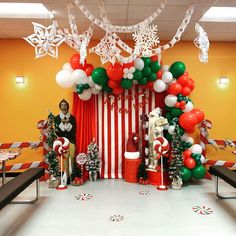 a room decorated for christmas with balloons and decorations