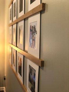 several pictures are hung on the wall with wooden frames