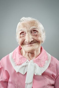 an old woman with white hair and pink shirt