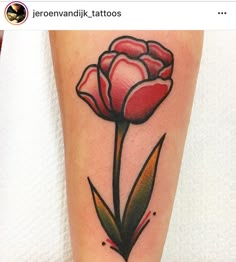 a red flower tattoo on the leg