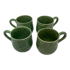 four green mugs sitting next to each other