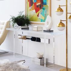 a living room with white walls and gold accents