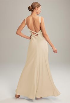 the back of a woman wearing a beige dress with an open back and straps on it