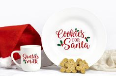 a white plate with cookies for santa on it next to two mugs and a napkin