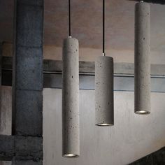 three concrete lights hanging from the ceiling