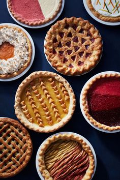 several pies are arranged in rows on the table