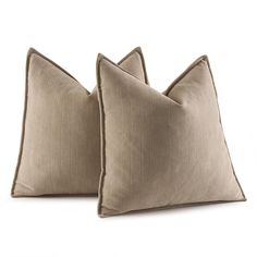 two beige pillows sitting on top of each other