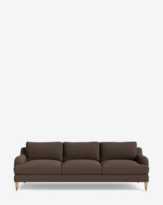 a brown couch against a white wall