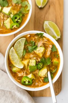 two bowls of chicken tortilla soup with avocado and cilantro