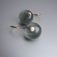 These simple drop earrings are made from the most beautiful moss aquamarine stones. The smooth, round, 13mm drops are a wonderful sea blue-green, with tiny, mossy inclusions and have been hung from satin-finished 14k gold earwires. The earrings hang 7/8" total. Minimalist Gemstone Round Earrings, Gold Aquamarine Drop Earrings, Handmade Aquamarine Drop Earrings, Aquamarine Gemstone Drop Earrings, Handmade Blue Aquamarine Earrings, Moss Aquamarine, Aquamarine Stone, Round Earrings, Dream Jewelry