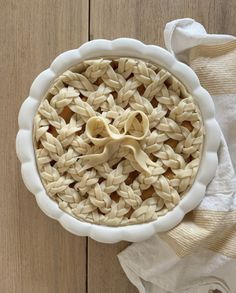 an uncooked pie sitting on top of a wooden table