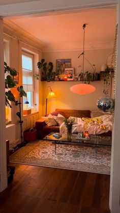 a living room filled with furniture and plants