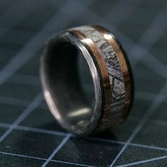 a wedding band with two tone gold and silver inlayed to the inside of it