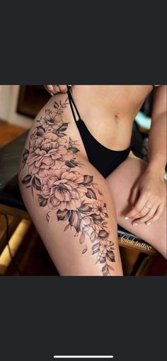 a woman's thigh with flowers on it