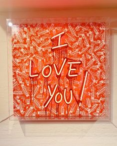 an orange and white painting with the words i love you written in red on it