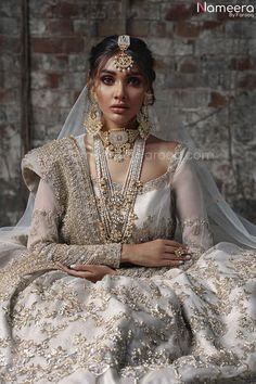 a woman in a bridal gown and jewelry