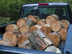 there is a truck with logs in the bed