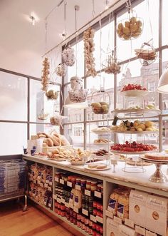 a display case in a bakery filled with lots of food and pastries on shelves