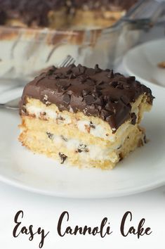 a piece of cake sitting on top of a white plate next to a glass dish