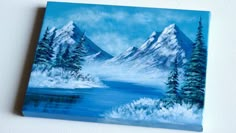 an acrylic painting of snow covered mountains and trees by the water's edge