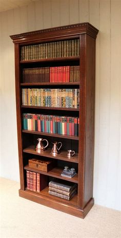 an old bookcase with many books on it