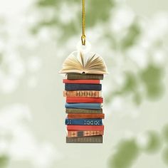 an ornament made out of books hanging from a chain