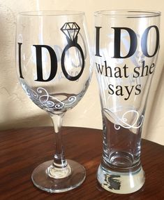 two wine glasses that say i do and what she says on them are sitting on a table