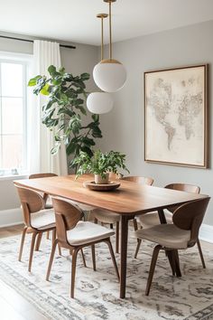 a dining room table with chairs and a potted plant in the center, hanging from a gold chandelier