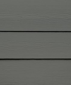 the side of a gray wooden wall