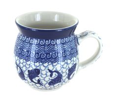 a blue and white coffee cup with fish on it's side, sitting in front of a white background