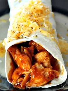 a burrito filled with chicken and cheese on a plate