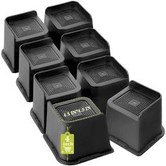 six black plastic containers with yellow labels on them