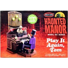 an old fashioned toy set with a man in top hat and purple shirt sitting at a desk