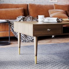 a coffee table with books on it in front of a couch