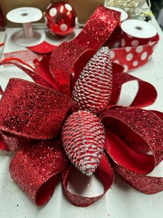 a red and silver christmas decoration on a table