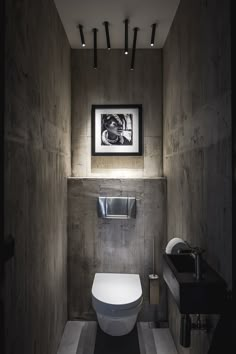 a bathroom with a white toilet sitting next to a sink