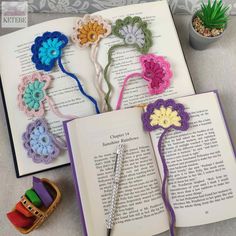 an open book with crocheted flowers on it