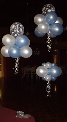 balloons and streamers are floating in the air at a party or function room setting