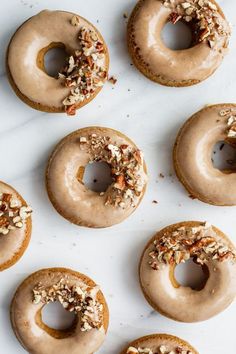 six glazed donuts with nuts on top