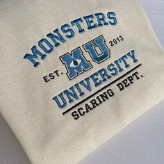 Monsters University embroidered design. (the year are not customisable) For mode designs ,please visit my shop. https://disneyembroiderygb.etsy.com Thank you! UNISEX HOODIE/SWEATSHIRT Fabric * 80% Cotton  * 20% Polyester Weight * 280 GSM - Soft cotton faced fabric. - Brushed back fleece. - Drop shoulder style. - Double fabric hood with self colour drawcord. - Front pouch pocket.(HOODIE ONLY) - Ribbed cuffs and hem. Monsters University Sweatshirt, Cute School Merch, University Hoodie Design, Team Hoodie Design Ideas, Hoodie Design Embroidery, Varsity Hoodie With Letter Embroidery For College, White Hoodie With Embroidered Text For College, School Spirit Sweatshirt With Embroidered Graphics, College Fan Apparel Hoodie With Embroidered Logo