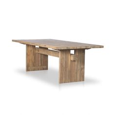 a wooden table sitting on top of a white floor