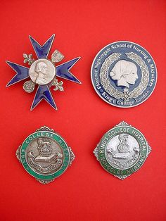 four medals are displayed on a red surface