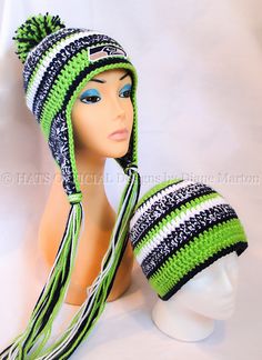 a mannequin head wearing a green and black knitted hat with tassels