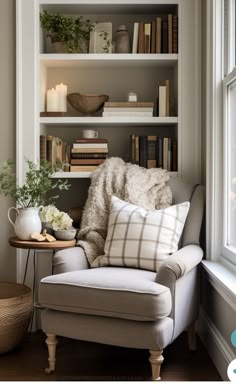 a white chair sitting in front of a book shelf filled with books